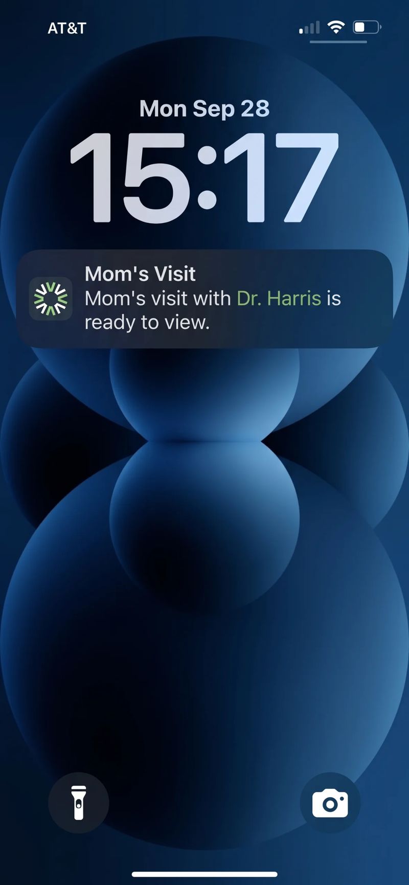 Phone lock screen showing a notification that a visit summary from Dr. Harris is ready to view